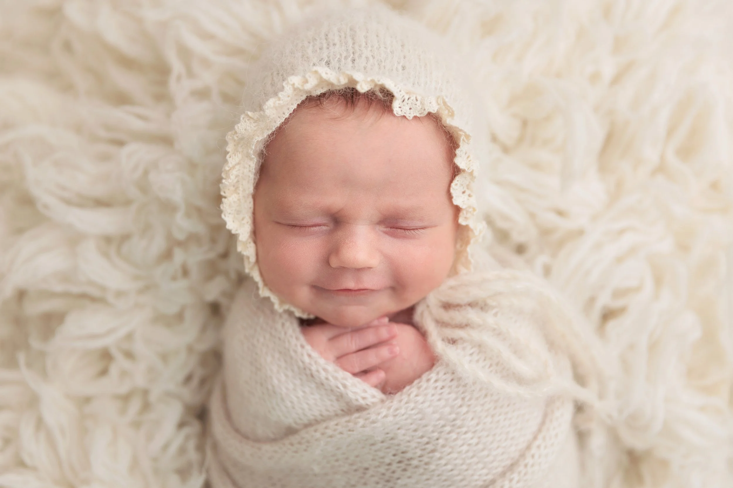 baby girl in a knitted bonnet