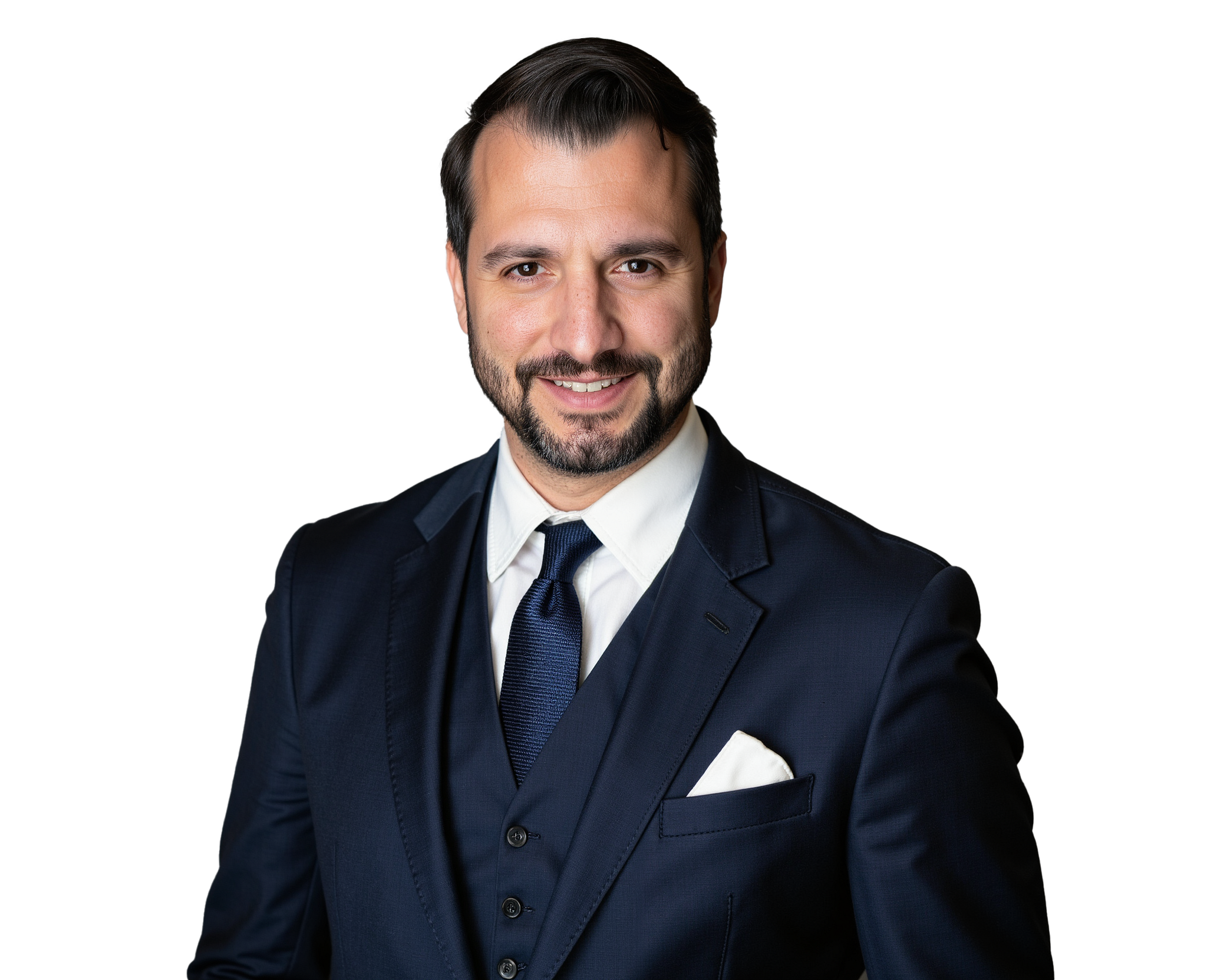 A man in a dark suit, white shirt, and a dark tie, smiling with a pocket square visible in his suit jacket.