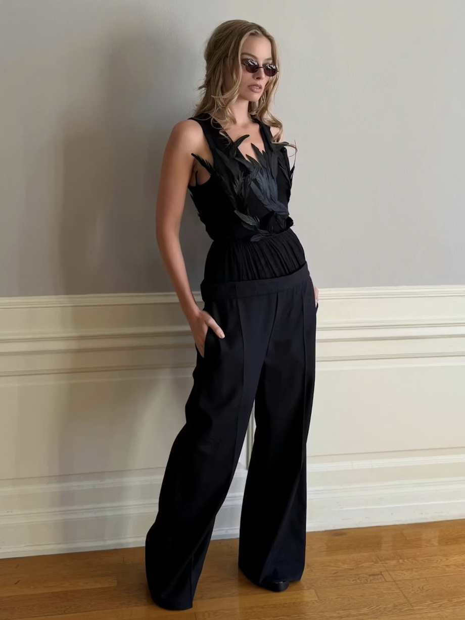  Robbie trades her white-feathered mini for a black-feathered corset&nbsp;  Photo: @andrewmukamal via Instagram 