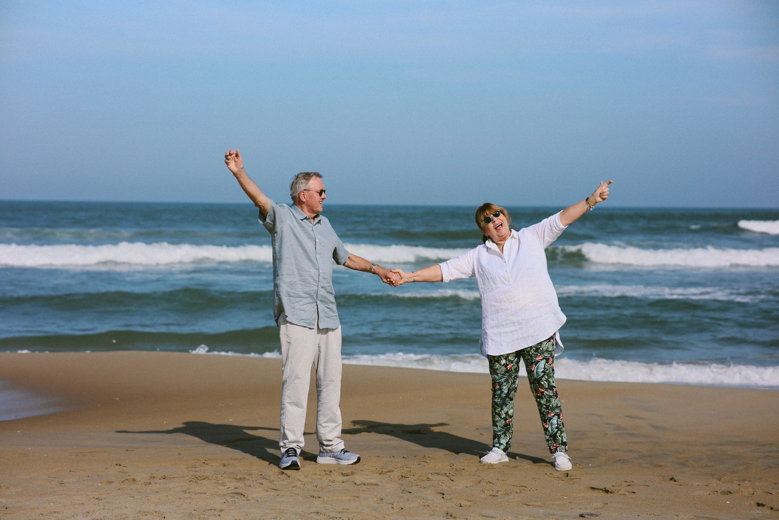Older retired couple dancing on a Florida beach.