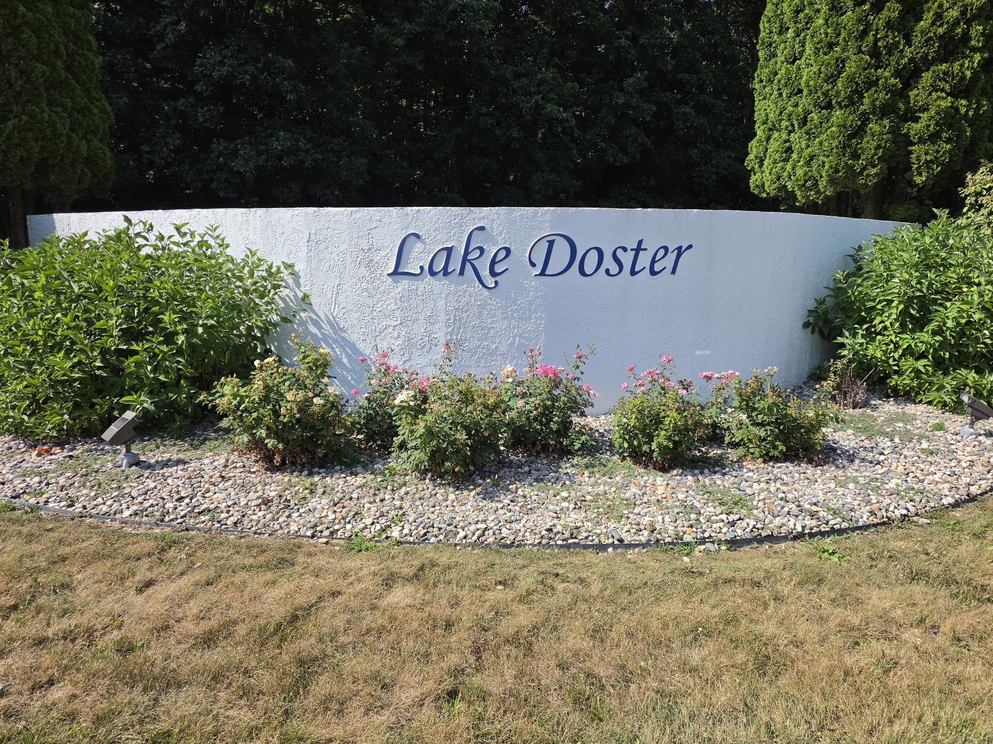 Beautiful sign with flowers at the entrance of the Lake Doster neighborhood