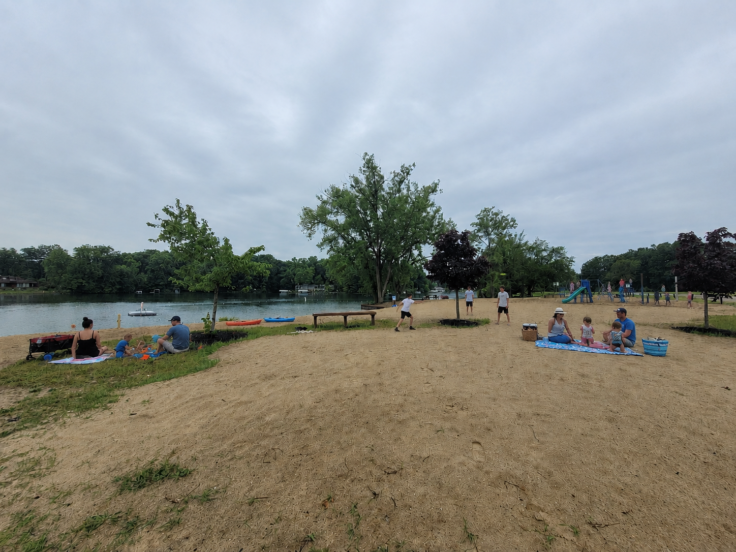 Families and friends enjoying the private beach of the Lake Doster community.
