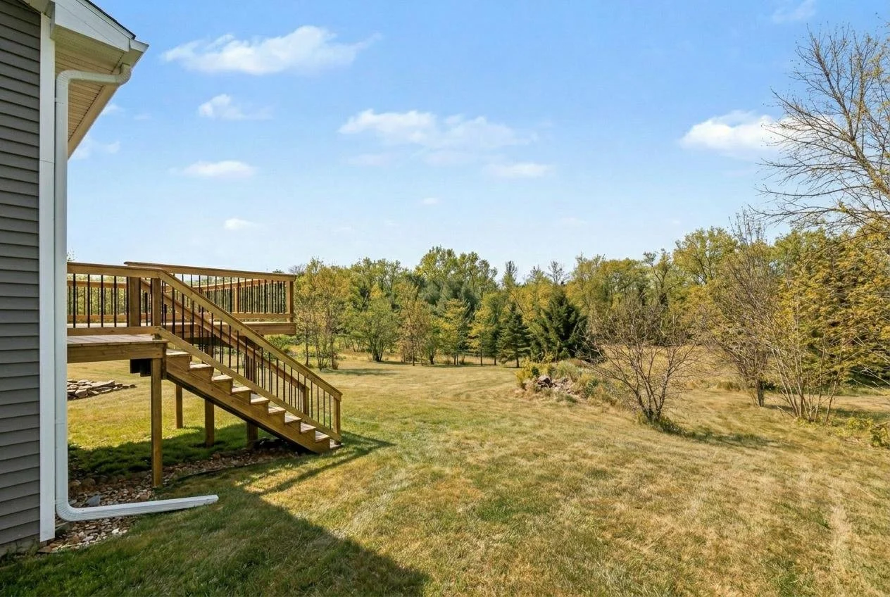 The back yard and green space and deck in the  move in ready, newly built house at 8683 Camomile.