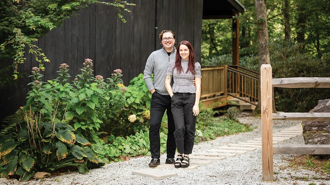 Photo of new owners standing in front of their barn