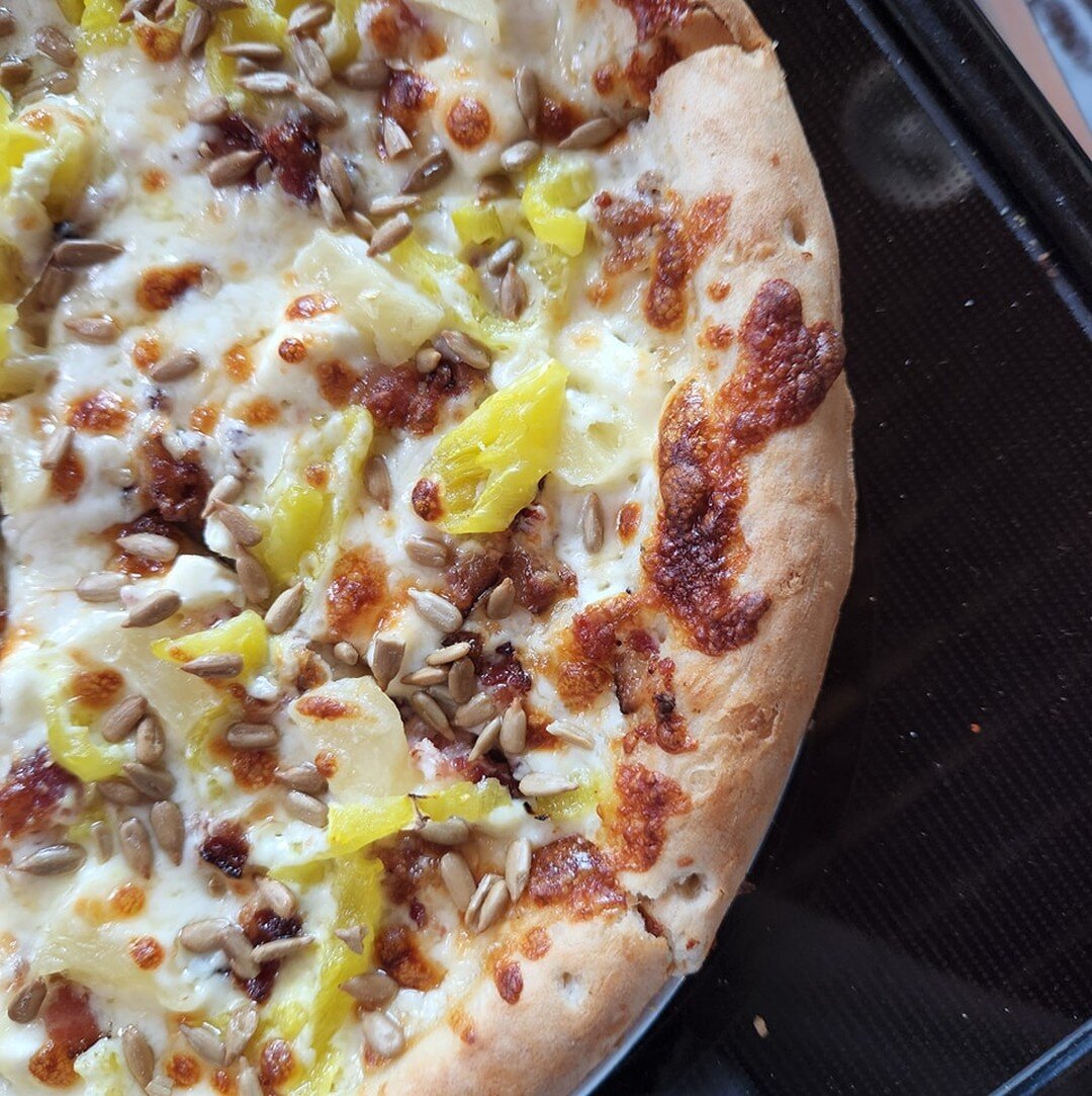 This week's #TBPPizzaSpecial is the Sunny Daze: cream cheese, bacon, banana peppers, pineapple and sunflowers on our garlic olive oil