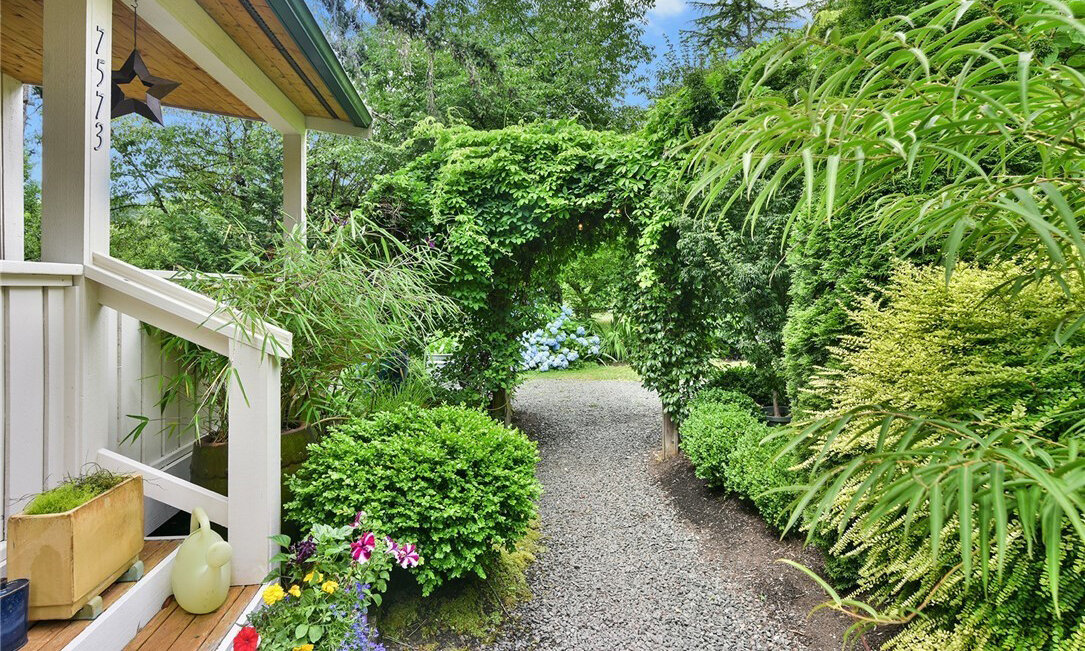  image of side yard pathway with arch and plants 