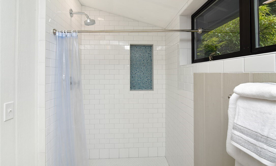  interior of bathroom with bathtub shower combo and window 