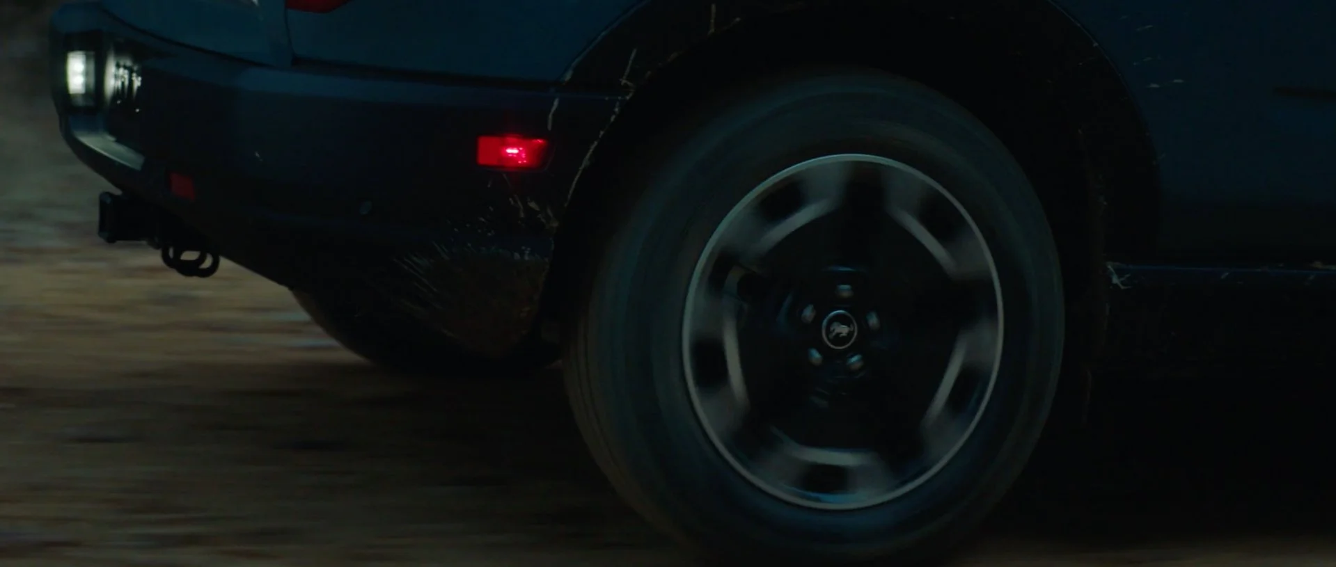 Ford Bronco Sport wheel and tire detail on gravel road.