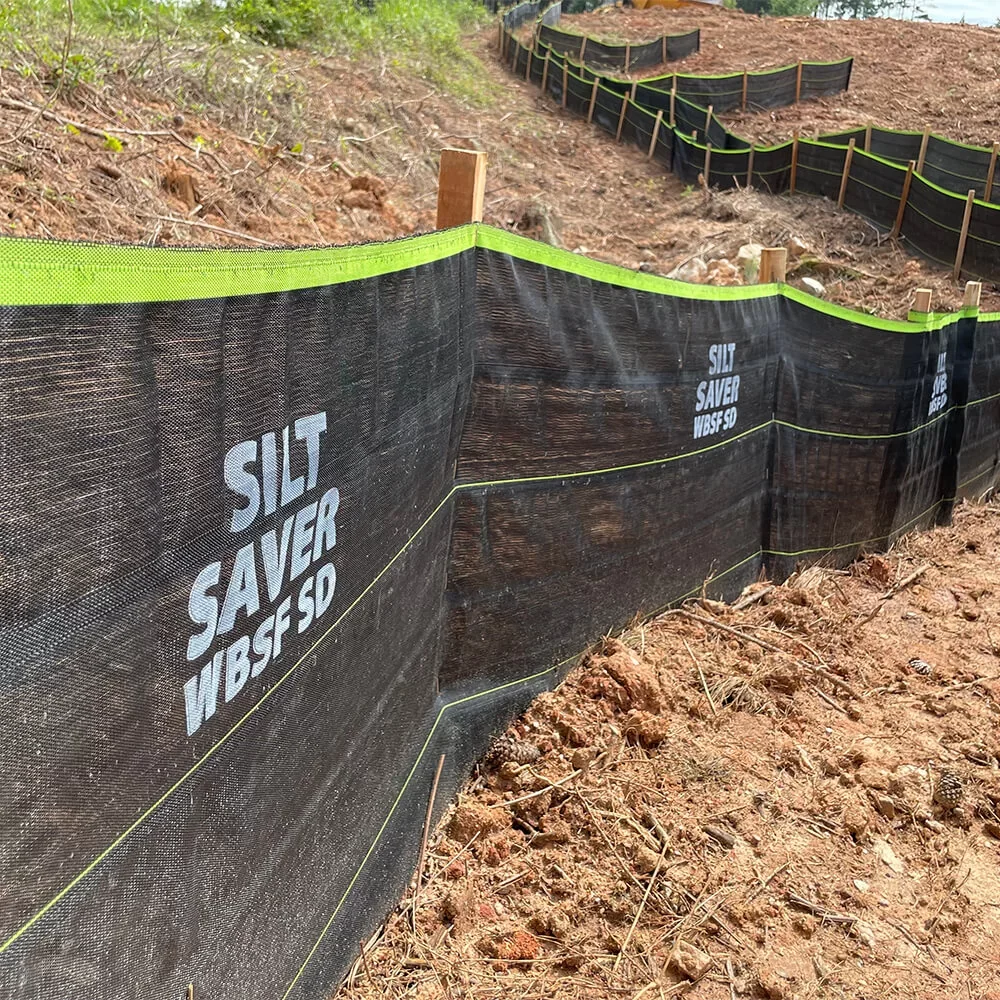 Silt Saver Woven Belted Silt Fence (WBSF) installed on a dirt bank.