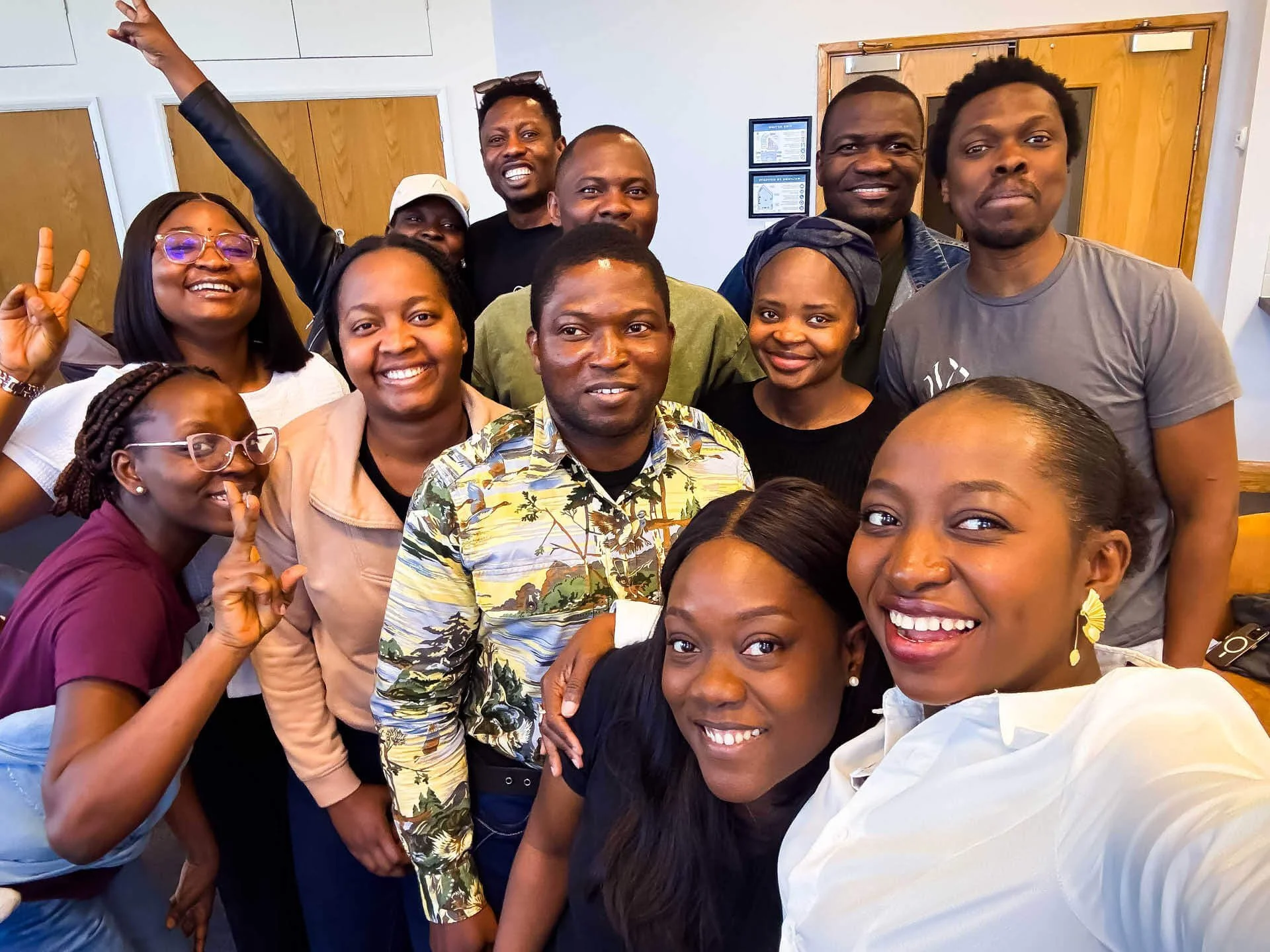 A life group of couples smiles together for a group photo.