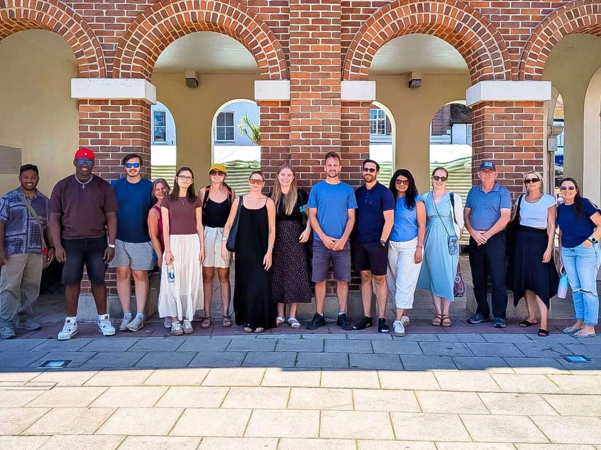 The Citygate team pose for a group photo on a Sunday day in front of arches.