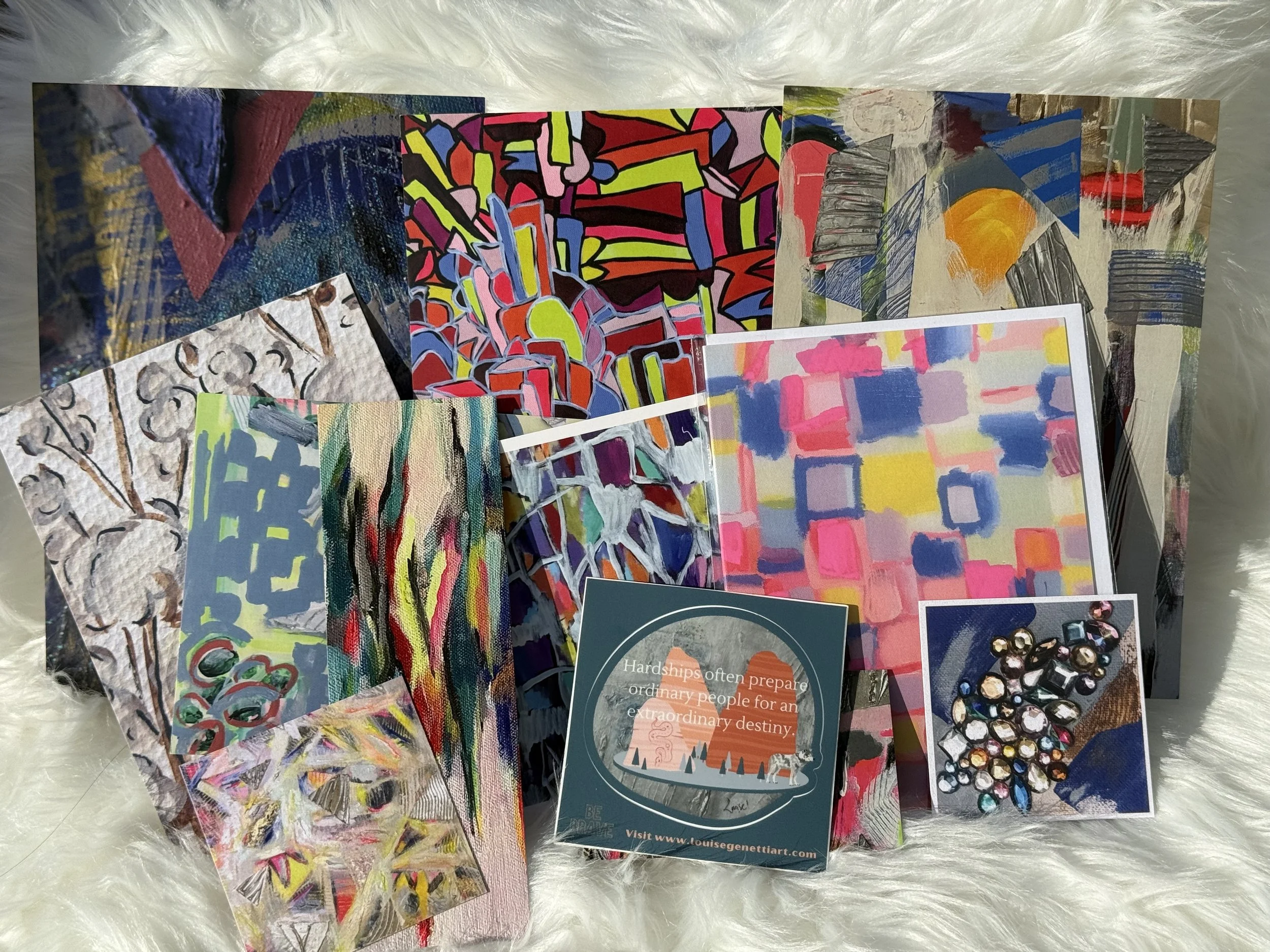 sample of contents found inside variety pack-Three 5x7 Postcards, Three 4x6 postcards, Two 2.5” cards, 1 bookmark, 1 blank notecard (4.25 x 5.5), 1 durable vinyl sticker