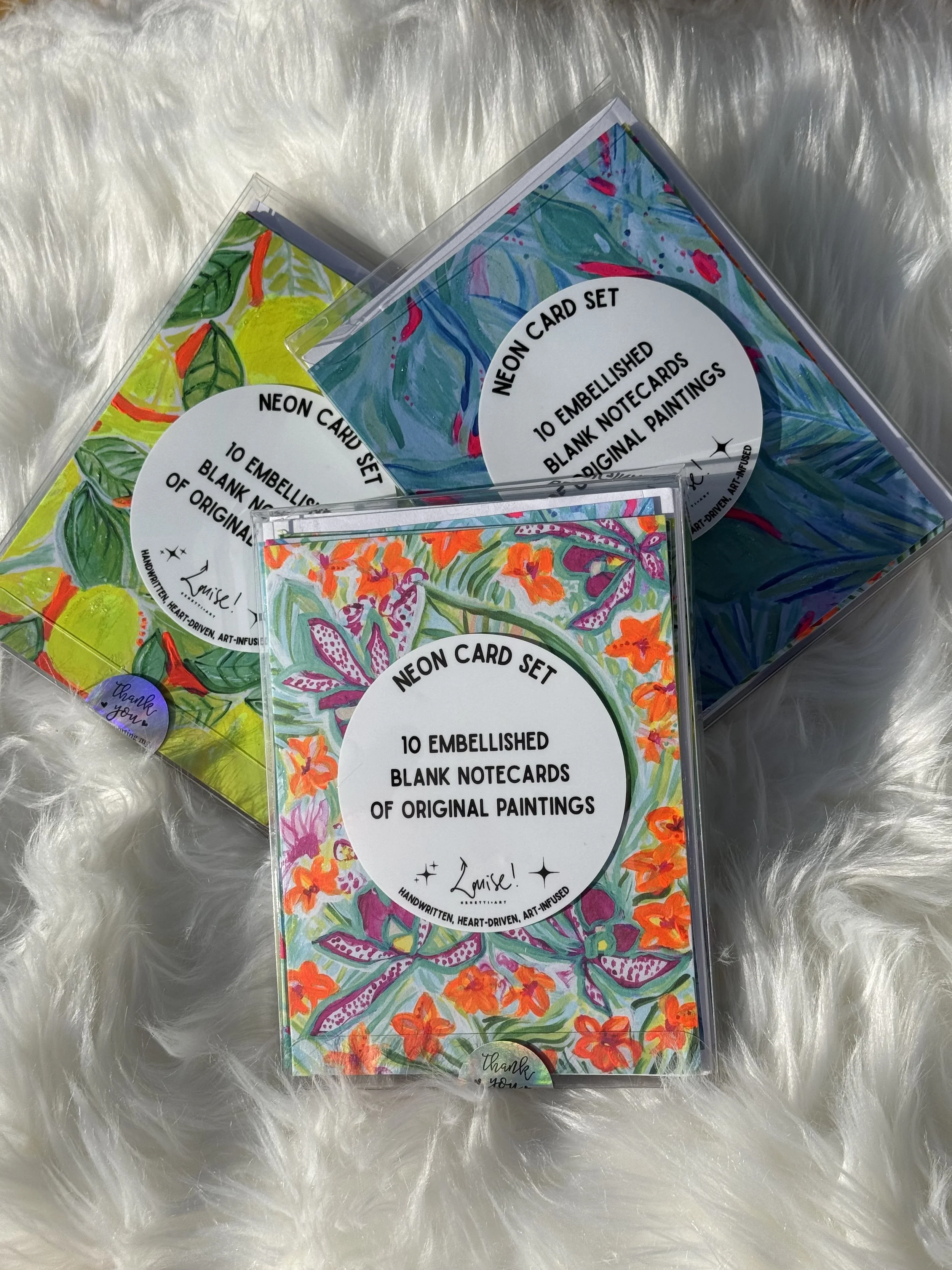 **ENC-FLWR (Box of 10 blank notecards) | Embellished with neon paint and glitter | 2 of 5 designs | 4.21" x 5.47" | Wholesale: $24; MSRP: $48 | no case size