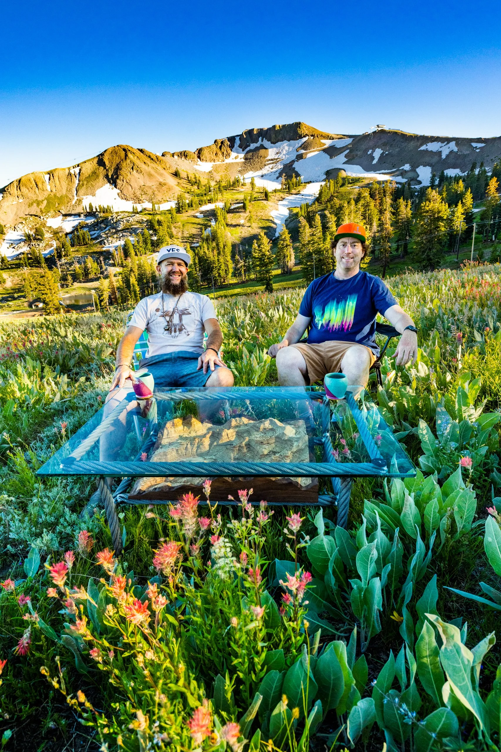 Mike and Grant in flowers t Palisades Tahoe Squaw Valley USA with their custom carved 3D wooden coffee table for Jones Snowboards showroom.