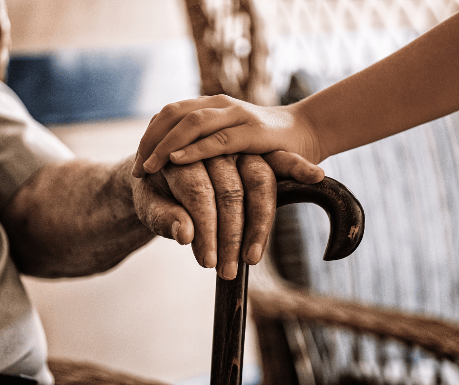 Elderly individual’s hand resting on a cane with a younger hand offering support, symbolizing contested guardianship cases and elder care disputes in Northeast Ohio.