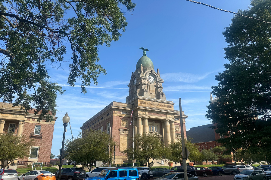 Lake County Courthouse in downtown Painesville, featuring a historic brick-and-stone building with a clock tower, dome roof, and columned entrance.