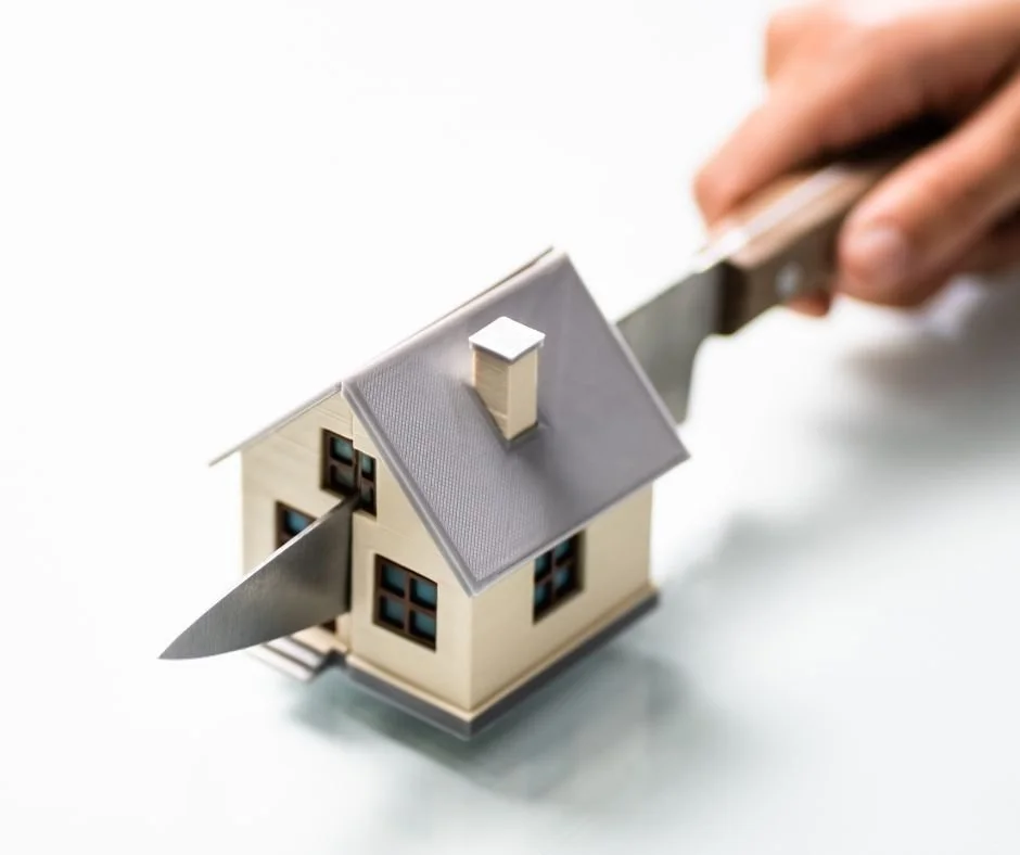 Scale model house being split by two blades, representing property ownership conflicts and legal disputes over shared real estate interests.