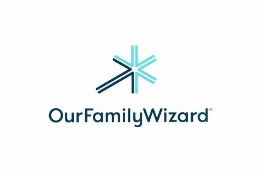 Our Family Wizard logo featuring a blue and teal star-like icon above the organization name, representing a co-parenting communication and scheduling platform.