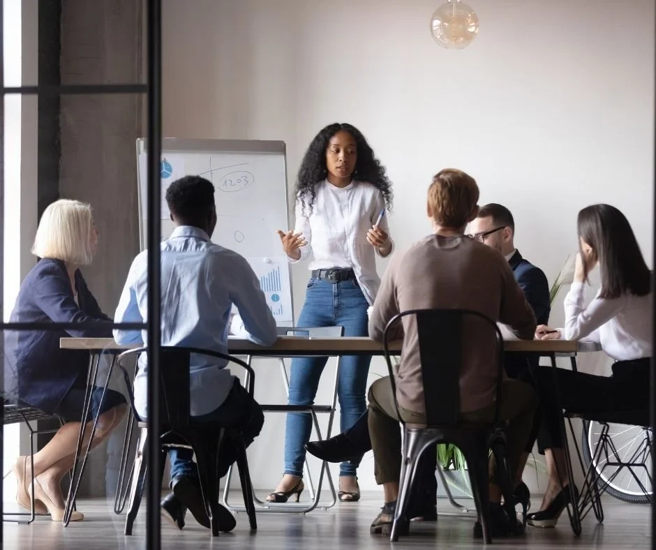 Group of professionals meeting at a conference table, representing business operations, commercial property disputes, and investment decision-making.