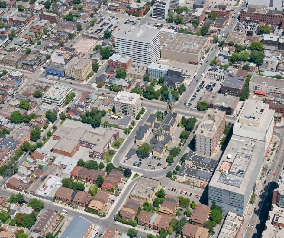Aerial view of a city block with mixed-use buildings and roads, representing zoning regulations, land use planning, and municipal development
