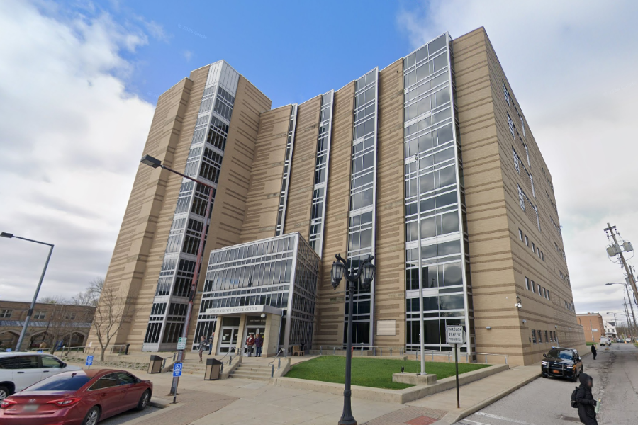 Lorain County Justice Center in downtown Elyria, featuring a modern multi-story courthouse building with large glass windows and a public entrance along Court Street.
