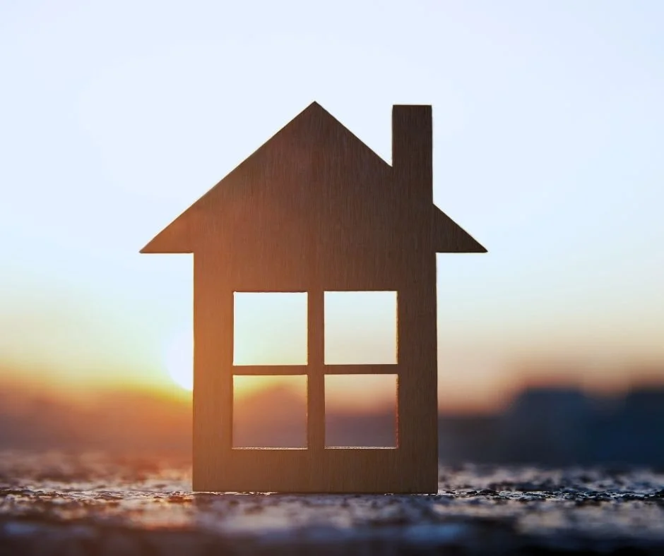 House silhouette against a sunset background, representing property ownership, lending considerations, and real estate financial matters.