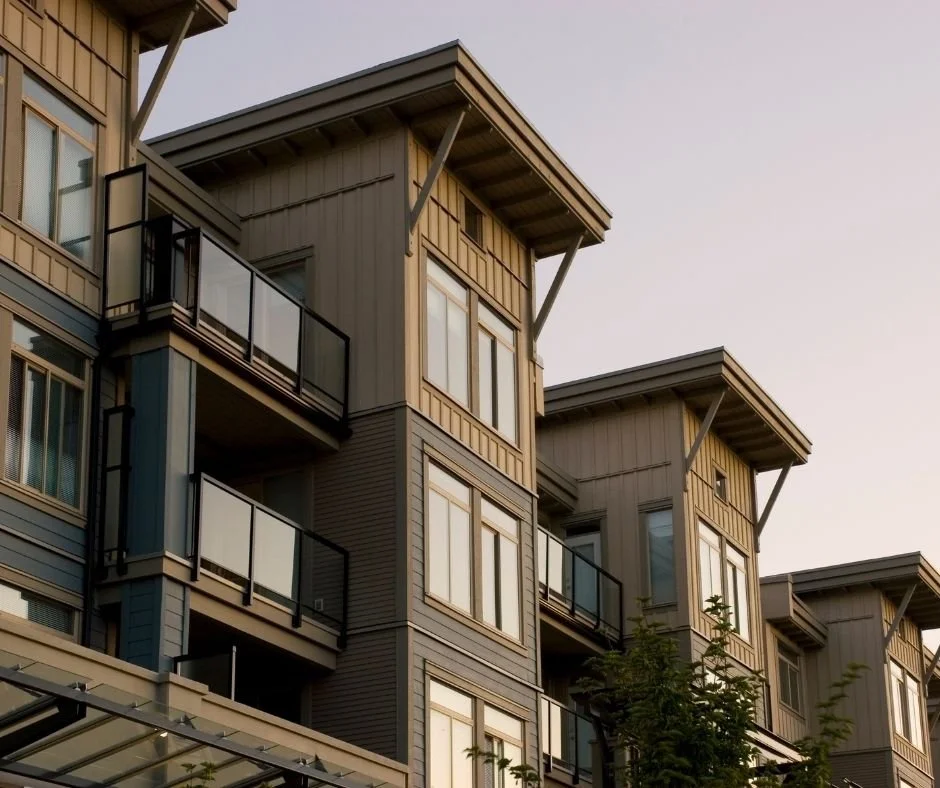 Modern townhome and condominium buildings with balconies, representing community associations and property governance.