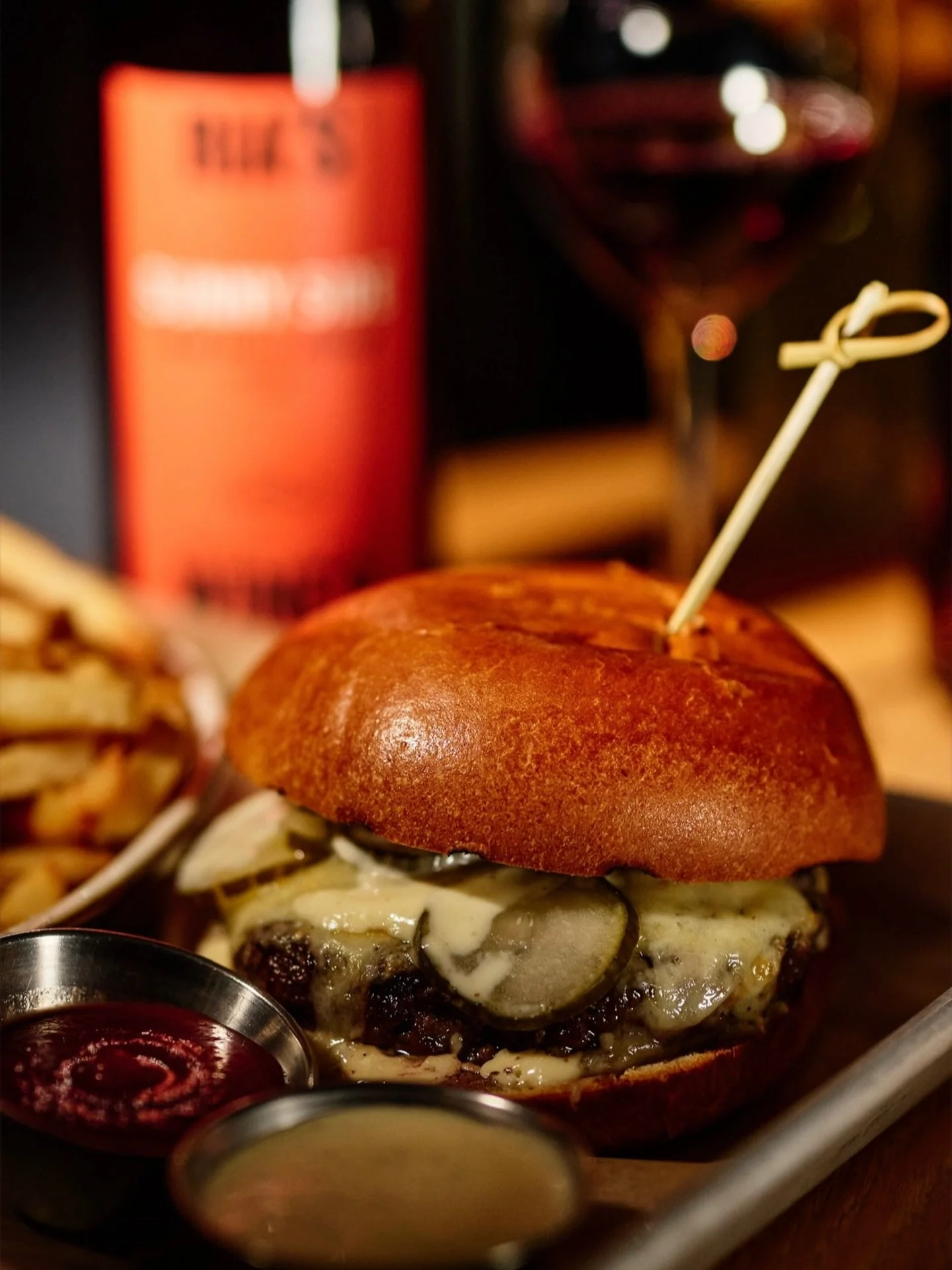 You don&rsquo;t need a reason, but today you have one. Comment 🔥 if a burger and a glass of wine is your kind of night. Happy Burger Day.