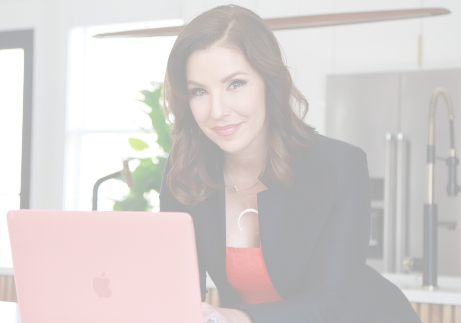 woman with computer and slight smile