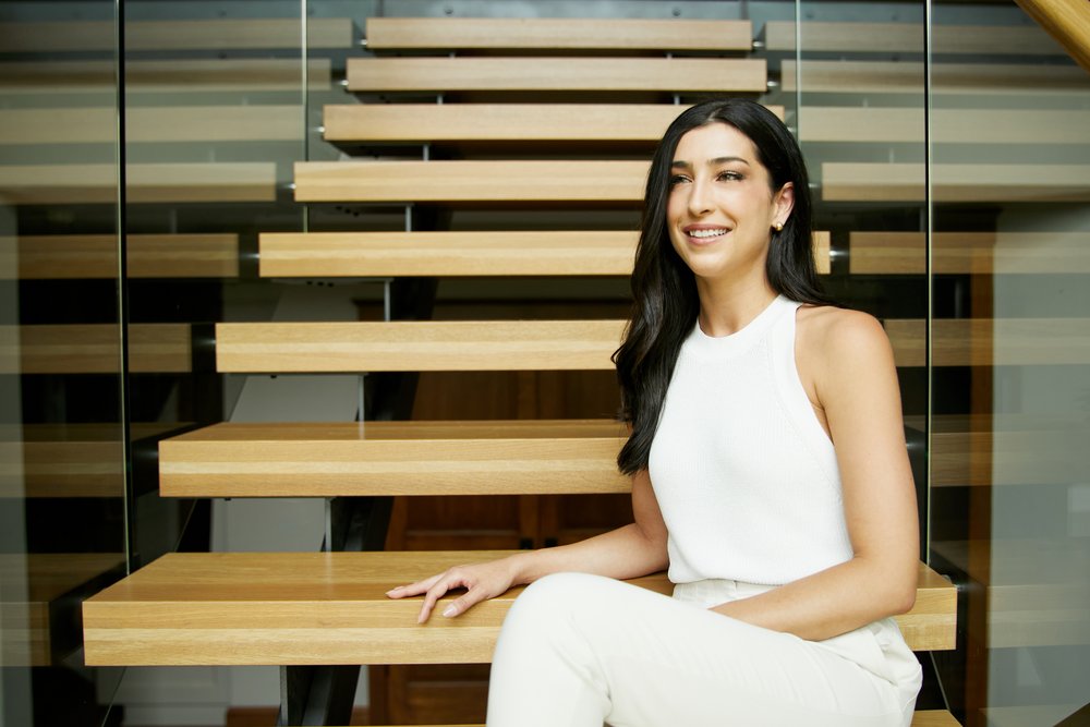 Beautiful real estate agent on stairs