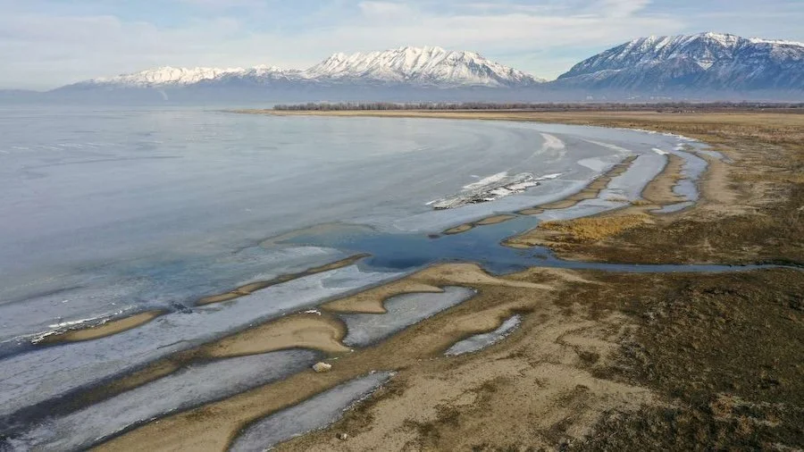 Aerial view of Utah Lake near Murray, Utah, with snow-covered mountains and frozen shoreline — symbolizing the stillness and reconnection often explored in somatic therapy.