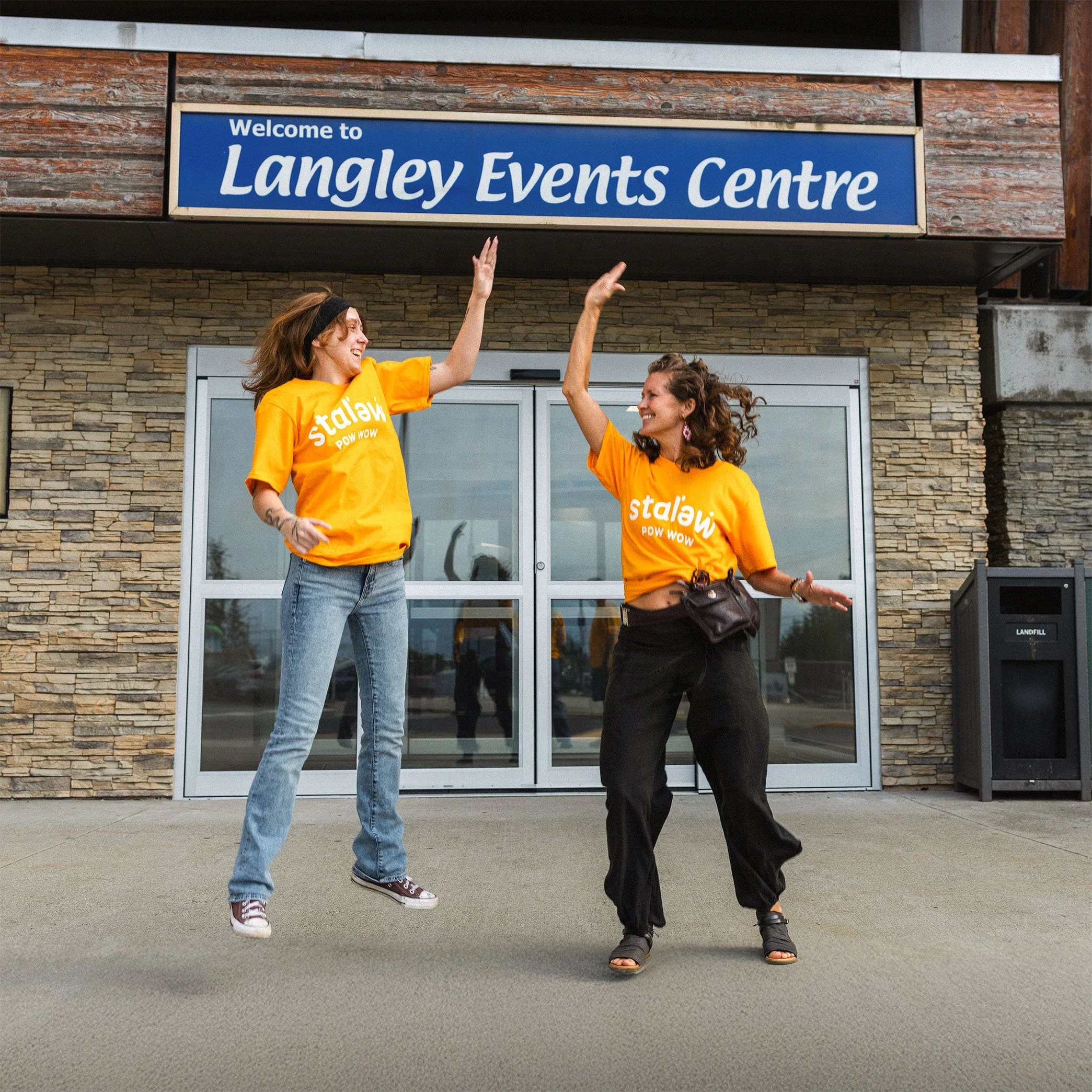 Two women wearing bright yellow t-shirts with