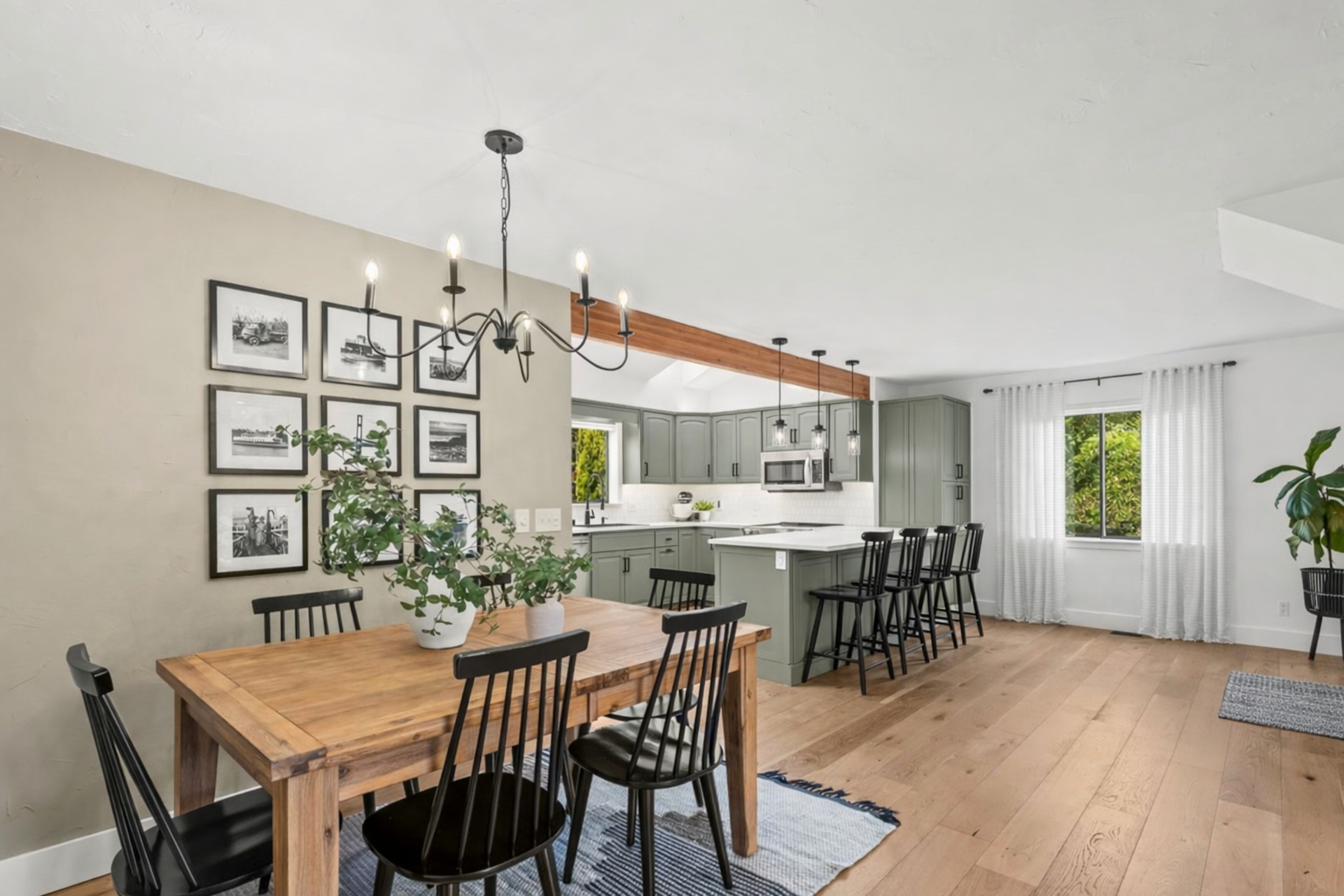 Gig Harbor North home open concept kitchen dining hardwood floors sage green cabinets wood beam StaciaSellsHomes