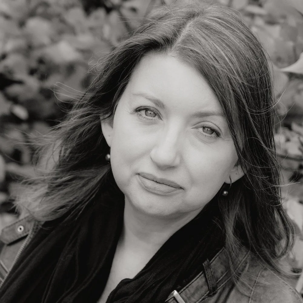 Black and white photo of Dodie Graham McKay, looking and smiling at the camera in an outdoor setting