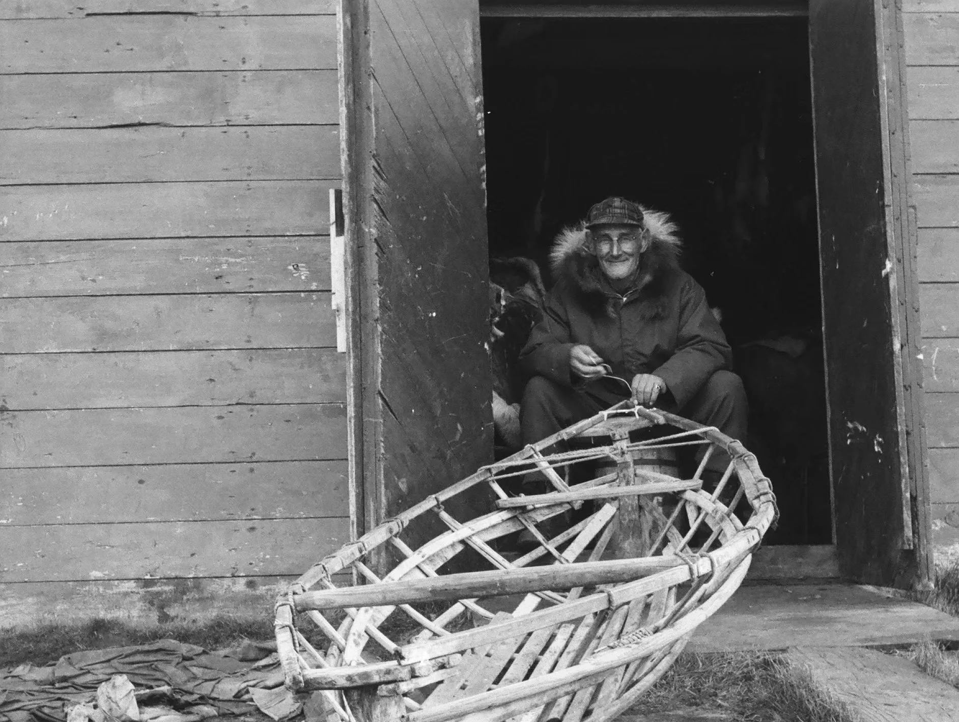 Kusiq Bodfish working on an umiaqaluraq in Wainwright, fall 1964.
