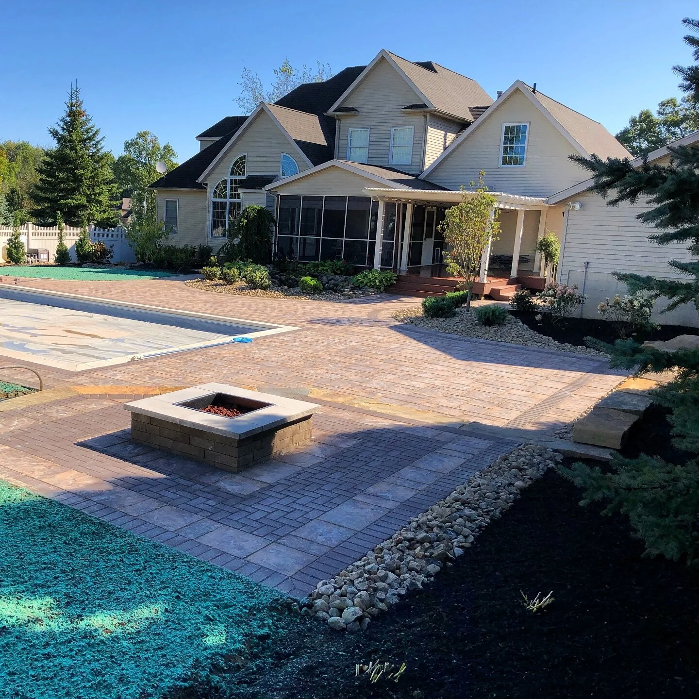 Paver patio with fire pit and inground pool in Nimishillen Township, OH