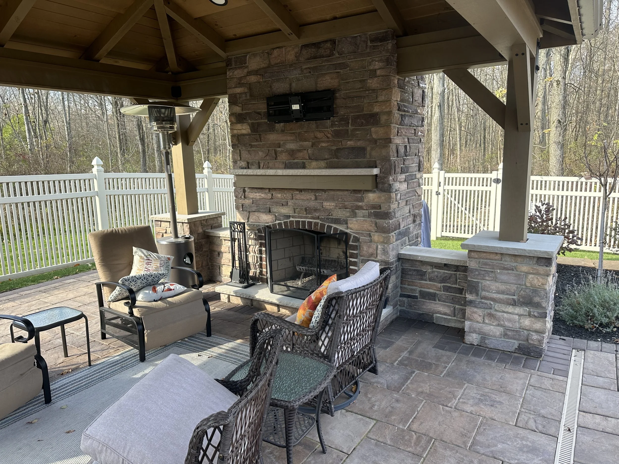 Create a Warm and Inviting Space With an Outdoor Fireplace and Plantings in Nimishillen Township, OH