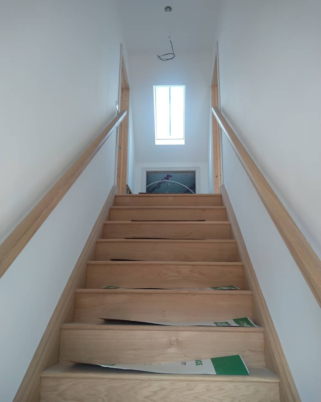 The wide oak stairs at our project near Attleborough fitted and ready to be oiled. Rooflight and light fitting nicely centralised on the stair.