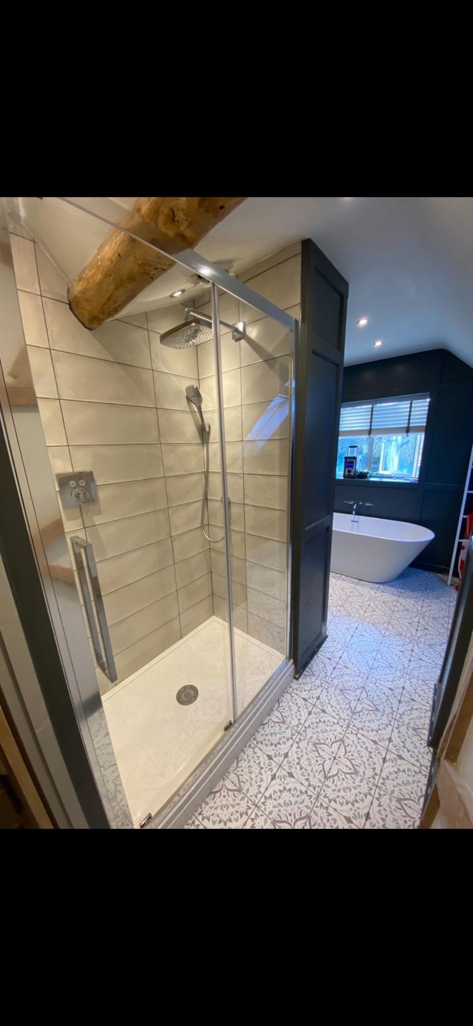 Impressive and spacious bathroom installed by Cotswold Vale showing shower cubicle and free standing bath