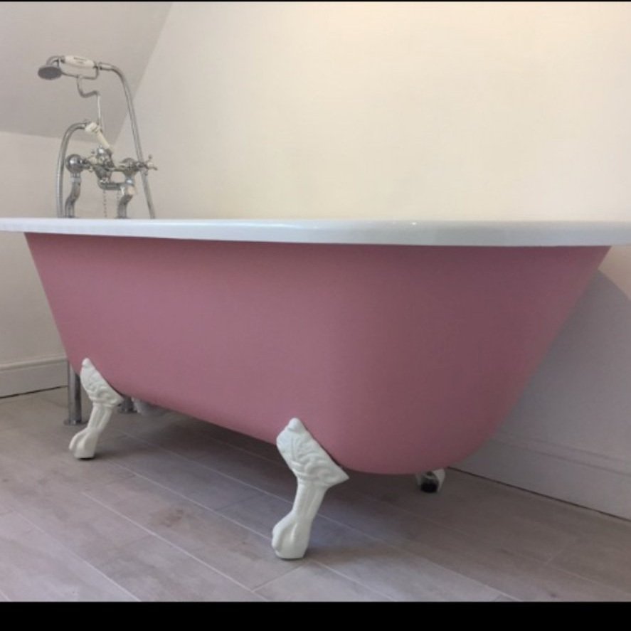 Close up of a unique looking pink free standing roll top bath installed by Cotswold Vale