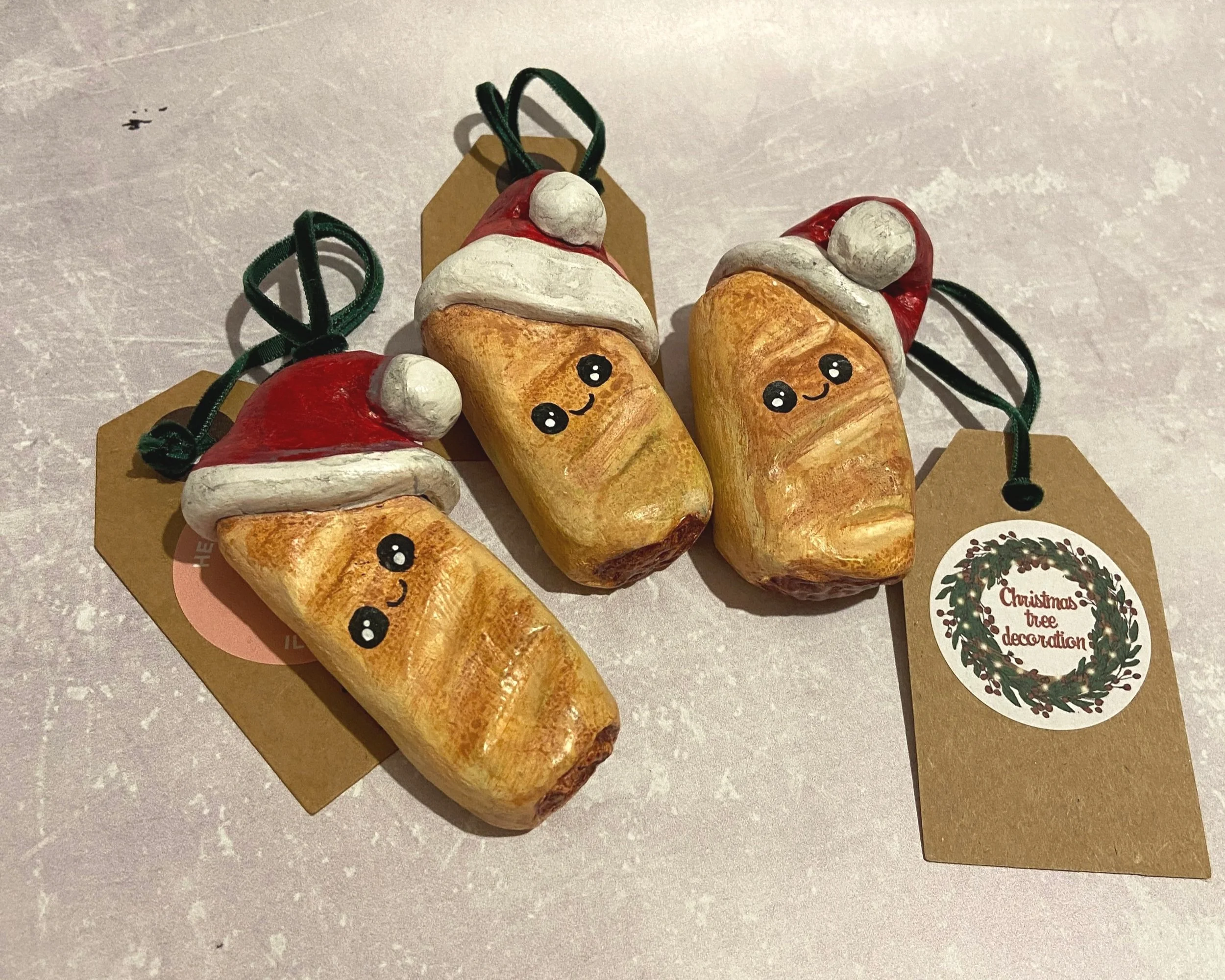Santa Sausage Roll Handmade cute kawaii food clay Christmas tree decorations handpainted by Devon artist Helen Leslie Illustrator