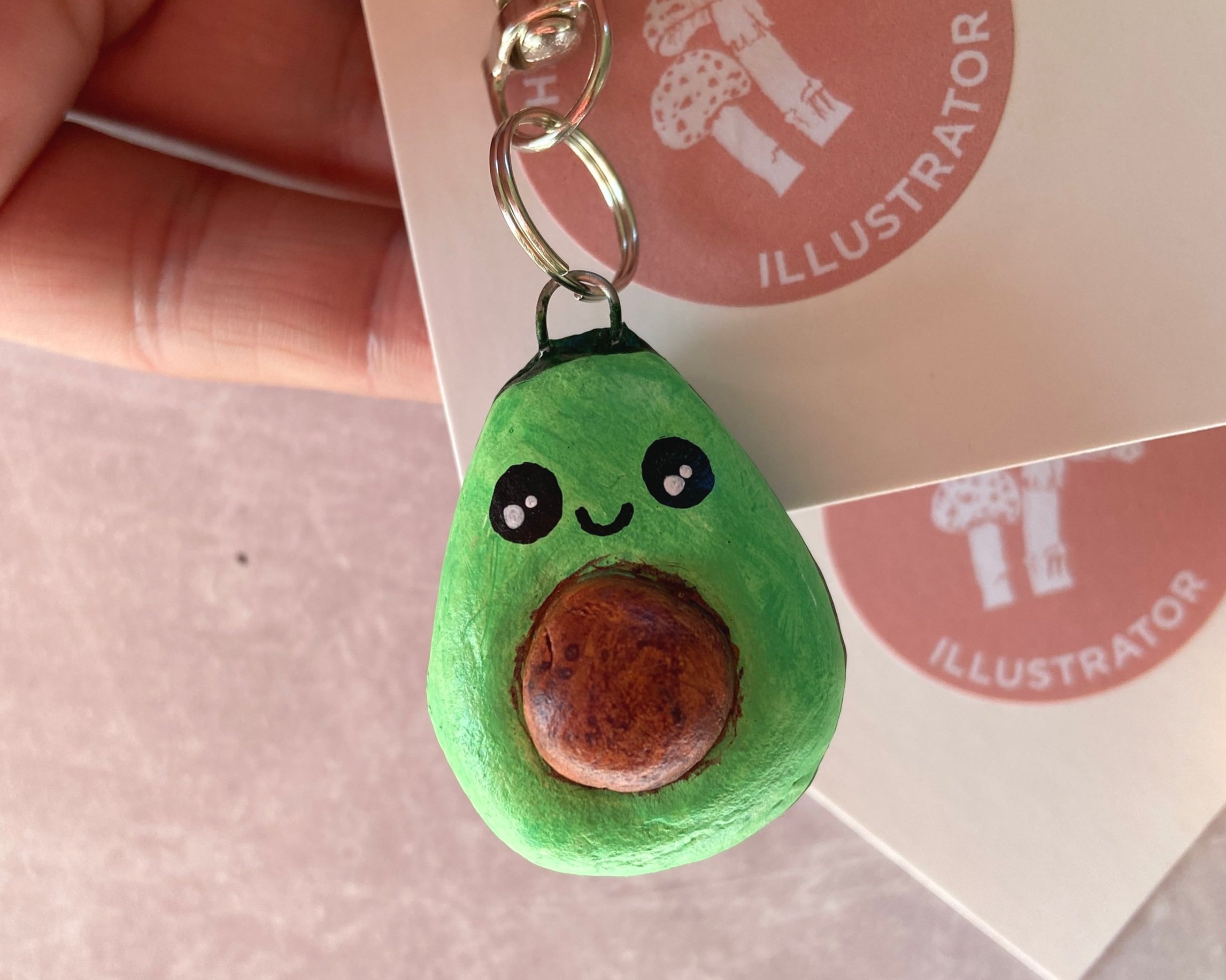 Cute avocado handmade clay bag charms, keyrings by Devon artist Helen Leslie Illustrator