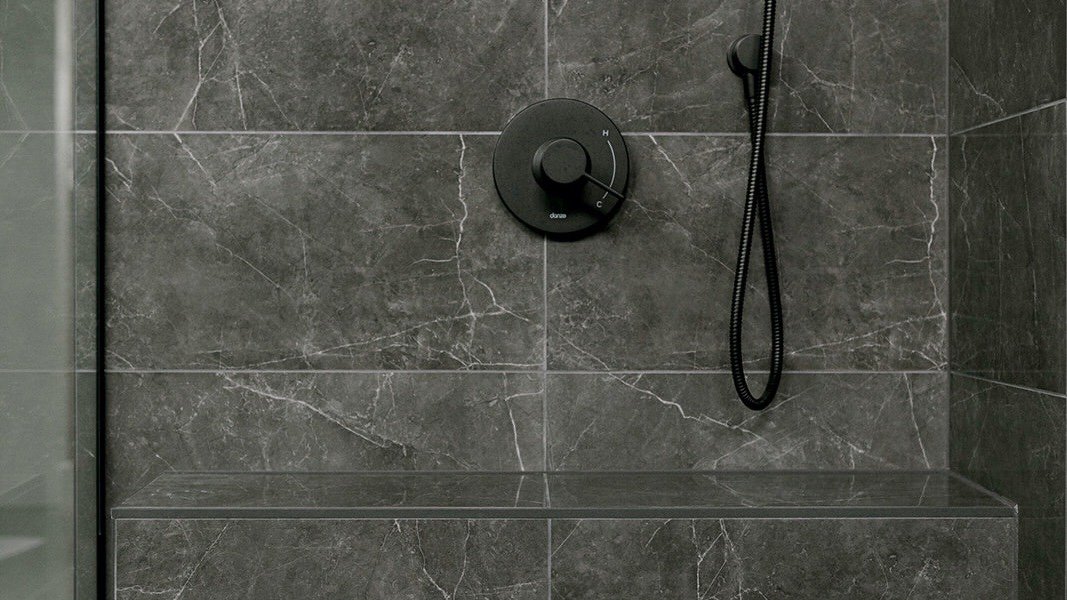 black quartz shower with matte black finishings