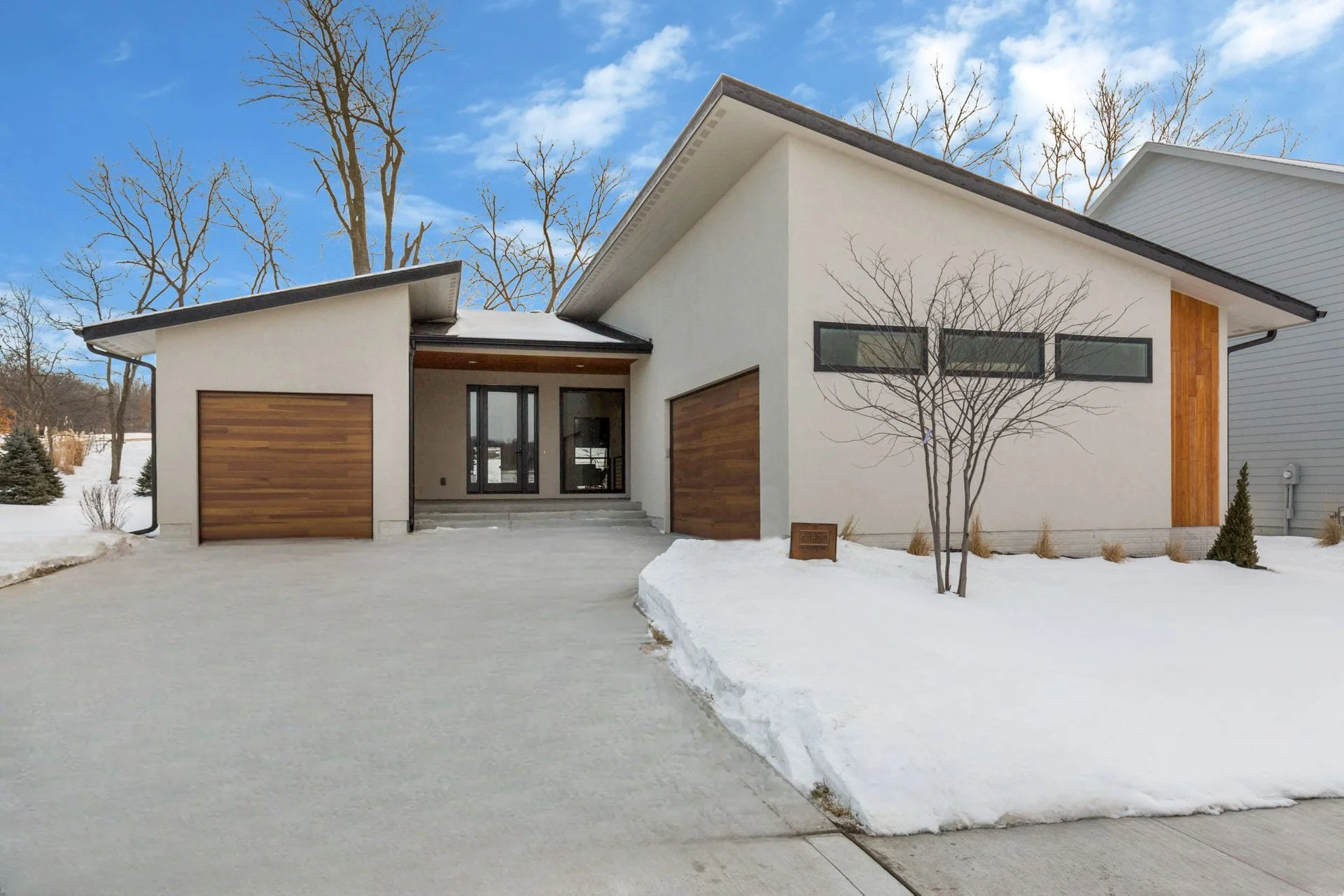 Modern two-bedroom house with wood paneled garage