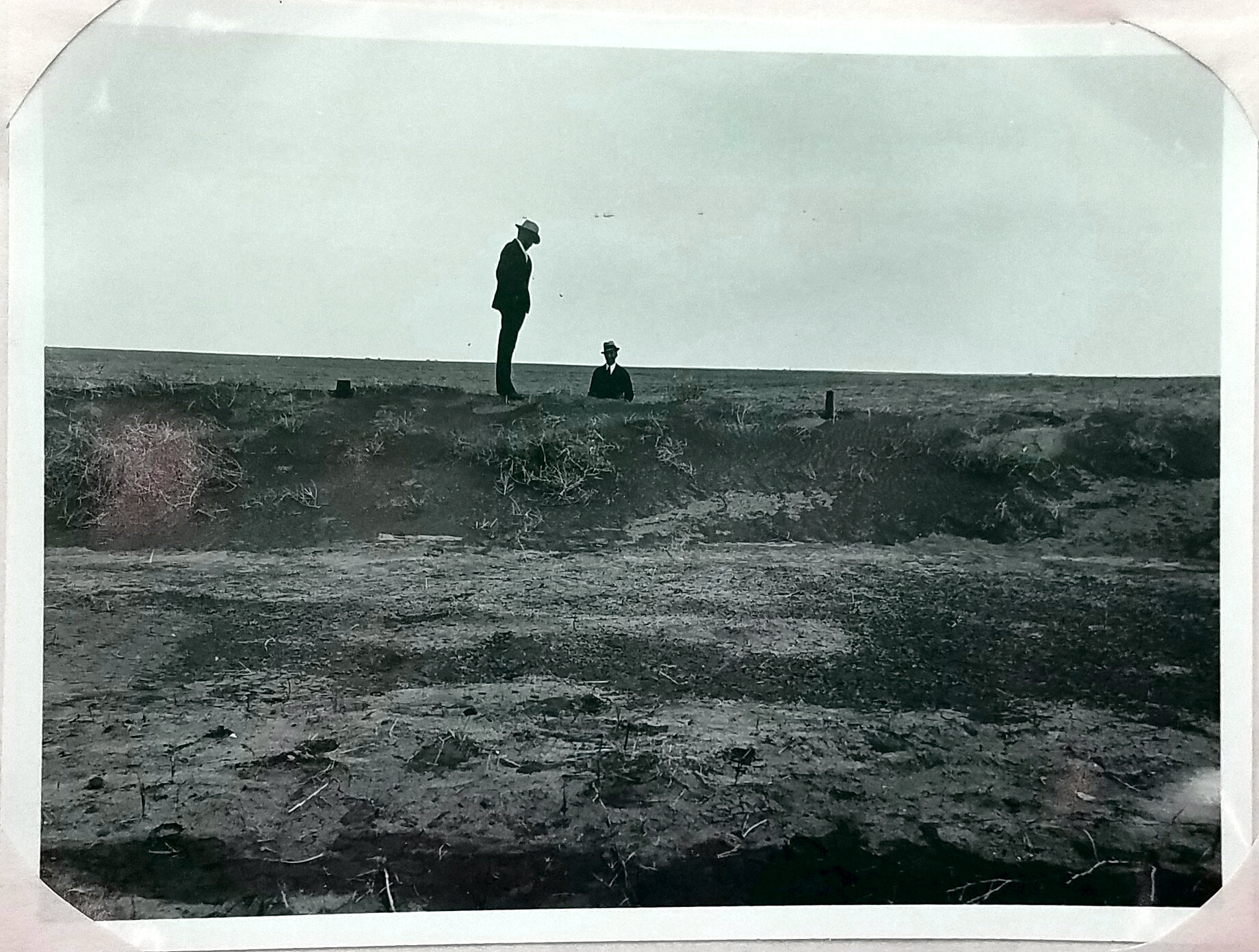 About 2 miles west of Sublette, KS. Railroad field fence drifted full of wind blown soil. In many places the 1932 tillage was all blown away. May 9, 1933. Figure 20 in Erosion Report by Bureau of Agricultural Engineering. National Archives, Record Gr