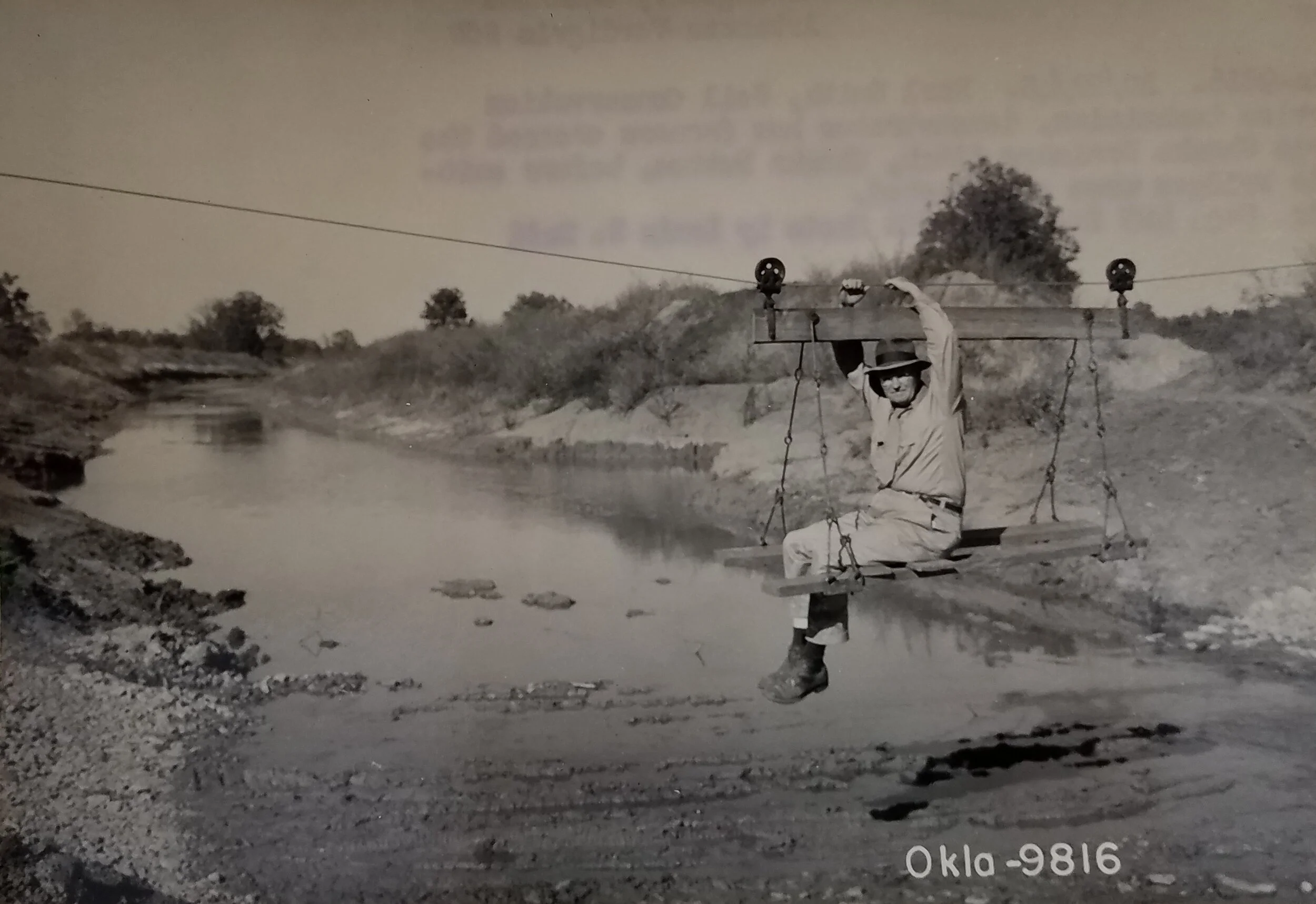 Earl Smith, SCS technician, demonstrates how farmers crossed a large drainage ditch before suitable bridges were constructed, Wagoner, Oklahoma. October 22, 1948. National Archives, Record Group 114, Entry 256.