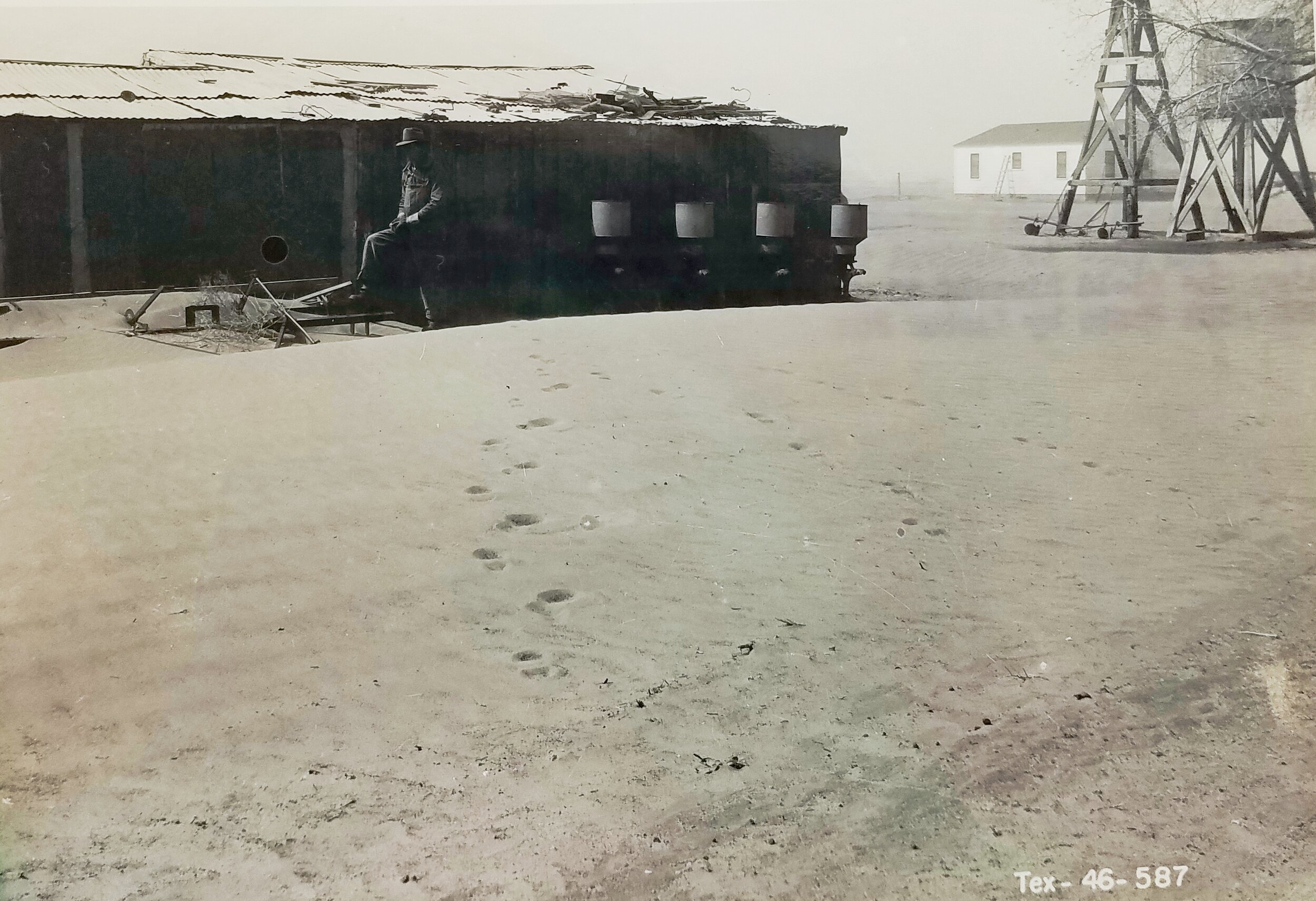 Drifting sand blowing in from nearby cotton field almost buried farm implements, Hockley County, Texas. April 6, 1950. Credit: Lester Fox. National Archives, Record Group 114, Entry 256.