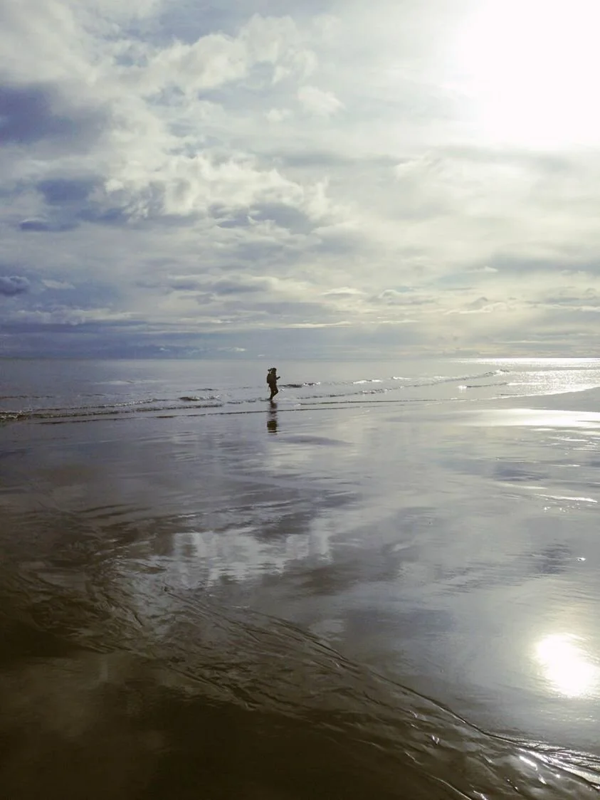 Walking a topographic survey line on a beach in Washington.