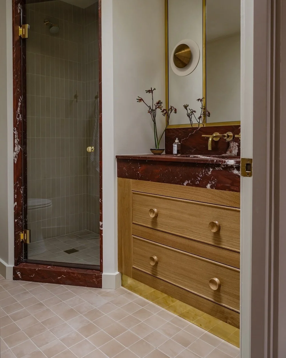 Red marble bathroom with brass accents.jpg
