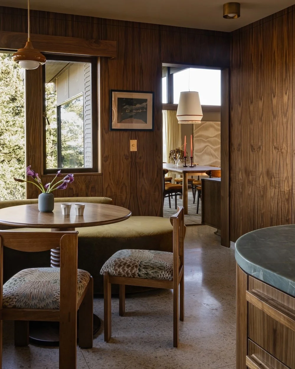 Midcentury modern breakfast nook with walnut wall panels.jpg